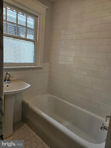 a bath tub sitting next to a window