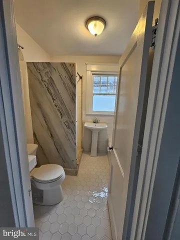 a white toilet sitting next to a small sink