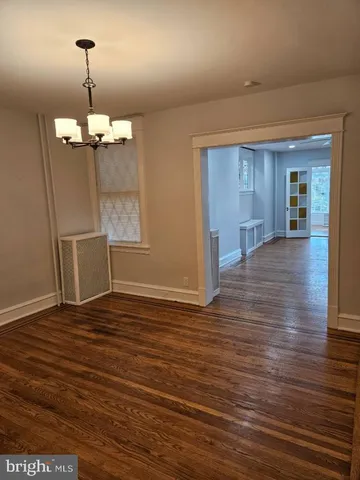 a view of a room with wooden floor and window
