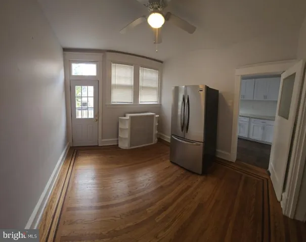 a view of kitchen with windows and refrigerator