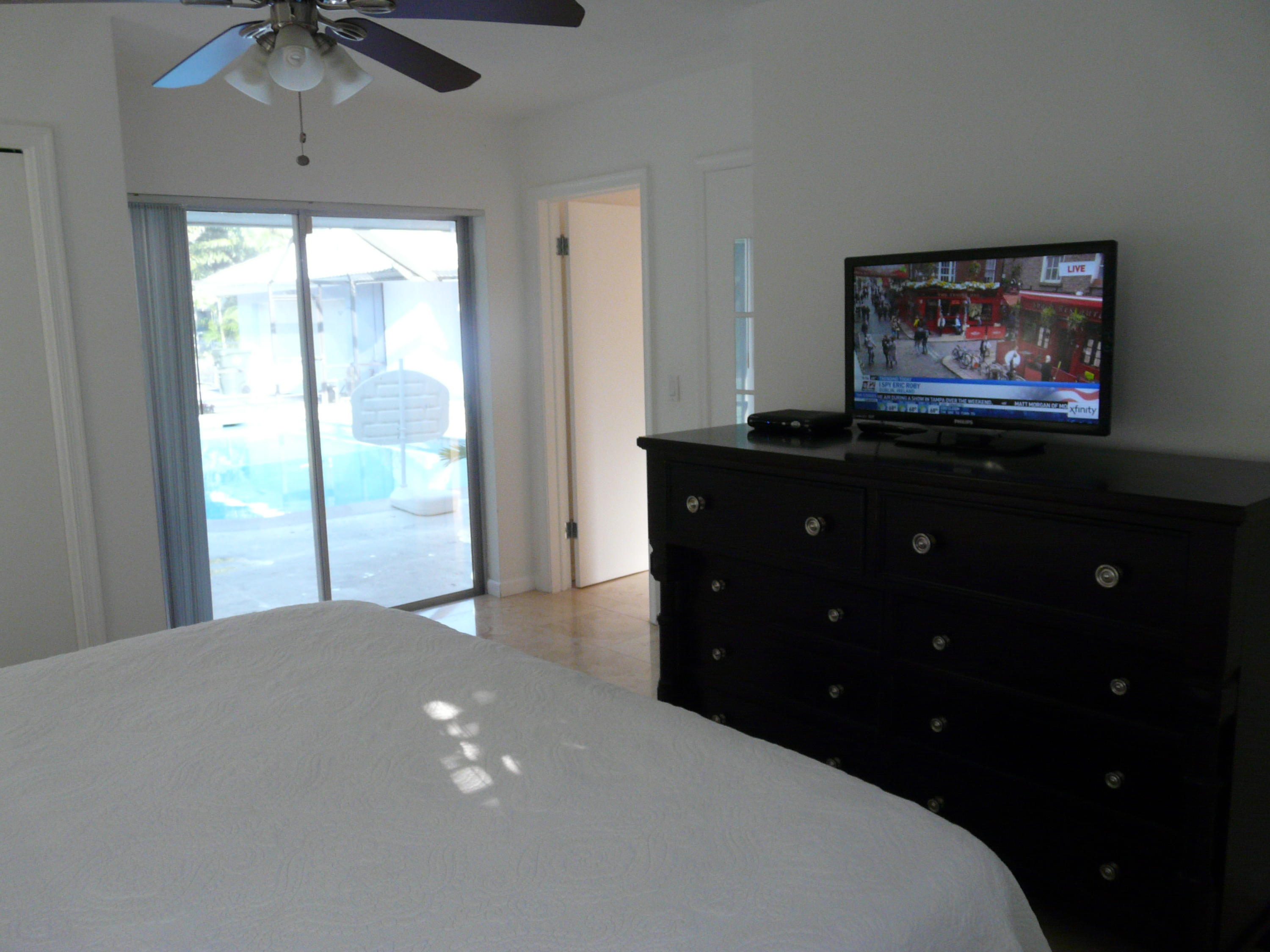 1120 Southwest 15th Street Boca Raton, FL 33486 - Photo 17 of 32 a bedroom with a bed and a chandelier