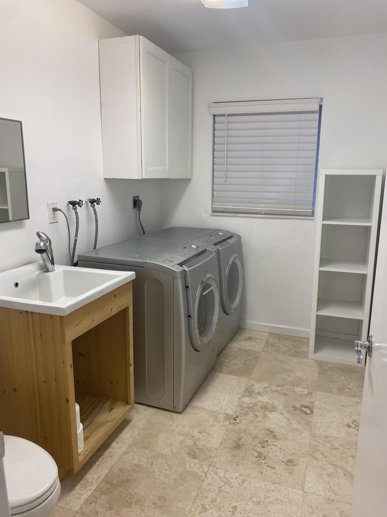 1120 Southwest 15th Street Boca Raton, FL 33486 - Photo 22 of 32 a utility room with sink dryer and washer