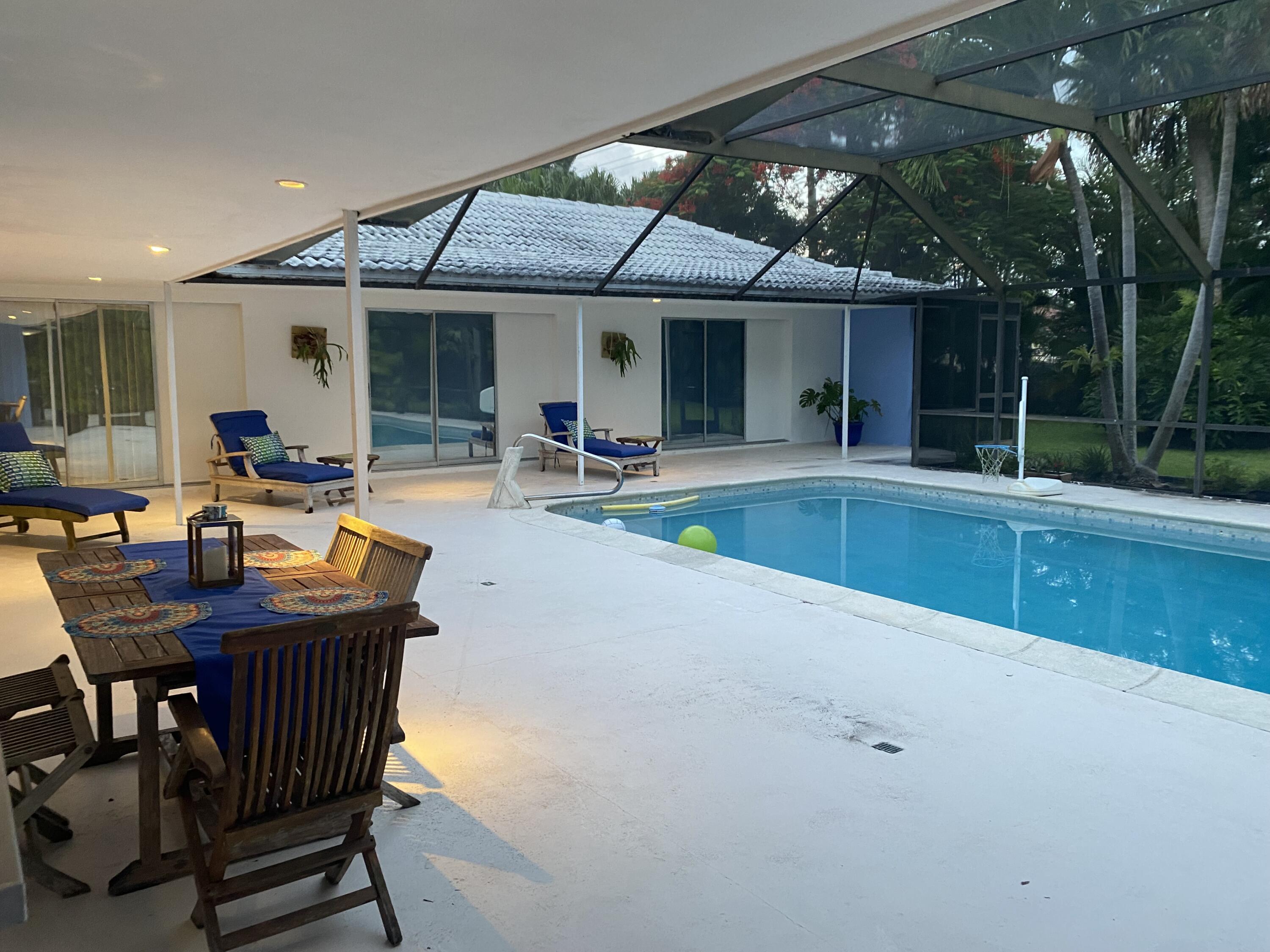 1120 Southwest 15th Street Boca Raton, FL 33486 - Photo 29 of 32 a swimming pool with outdoor seating and yard