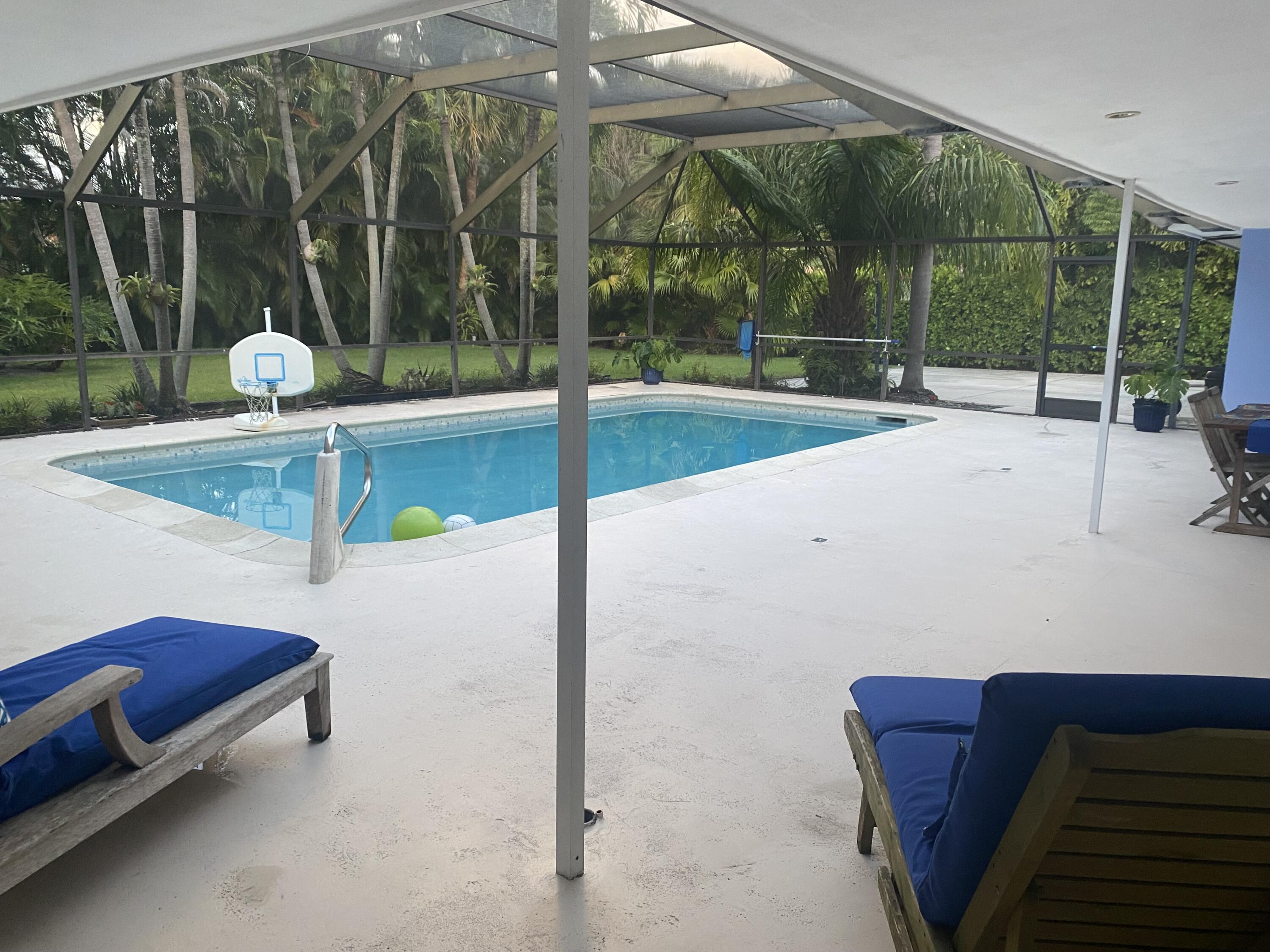 1120 Southwest 15th Street Boca Raton, FL 33486 - Photo 31 of 32 a living room with a floor to ceiling window and a table
