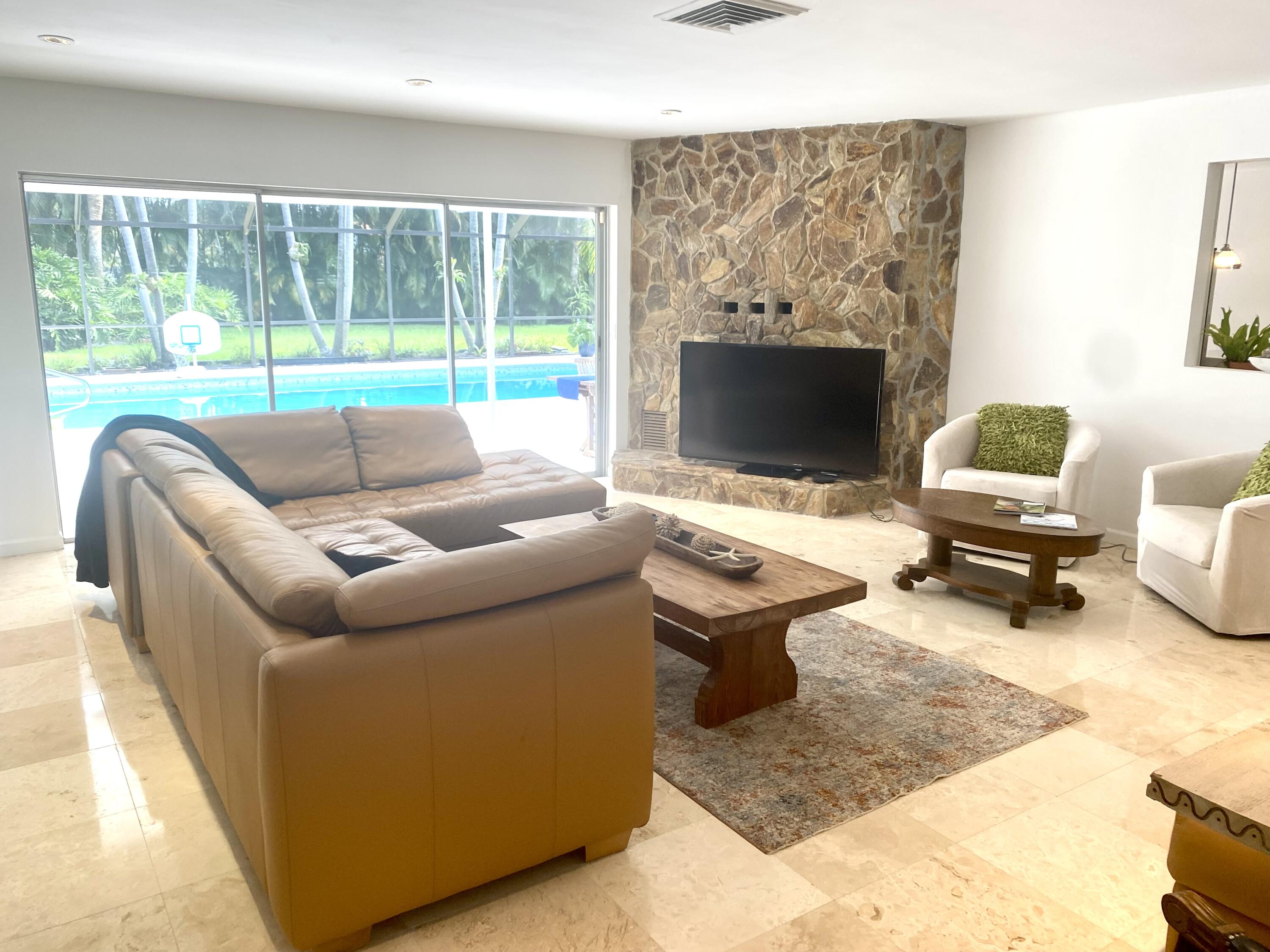 1120 Southwest 15th Street Boca Raton, FL 33486 - Photo 5 of 32 a living room with furniture and a flat screen tv
