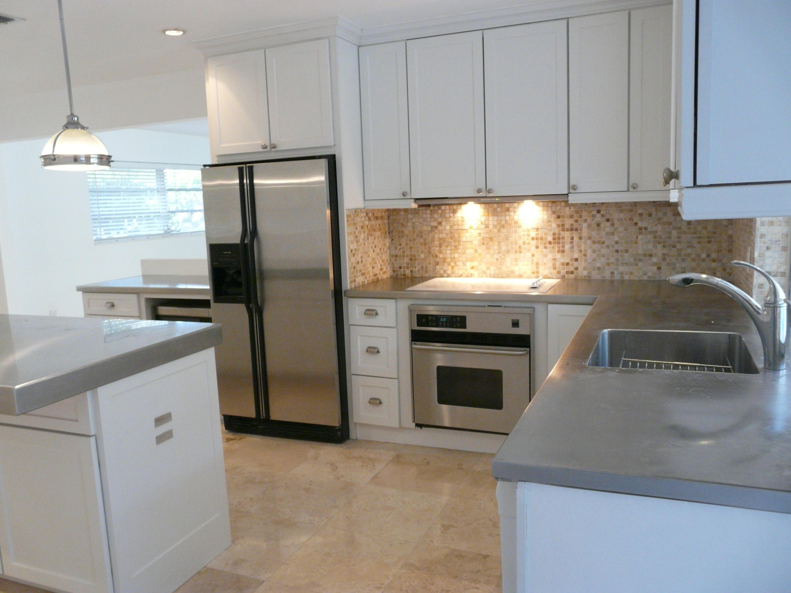 1120 Southwest 15th Street Boca Raton, FL 33486 - Photo 8 of 32 a kitchen with granite countertop a refrigerator stove and sink