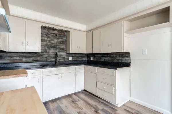 a kitchen with stainless steel appliances a cabinets a stove a sink and a microwave