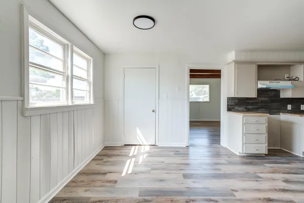 a view of a kitchen cabinets and empty room