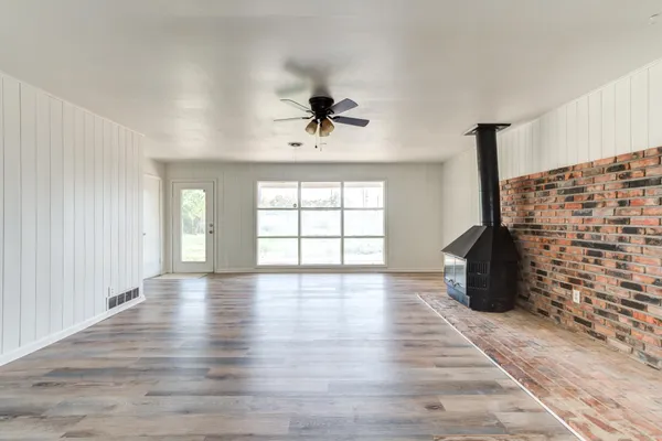 wooden floor in an empty room with a window