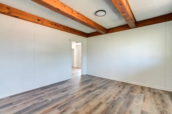 a view of a room with wooden floor
