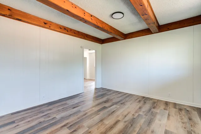 a view of a room with wooden floor