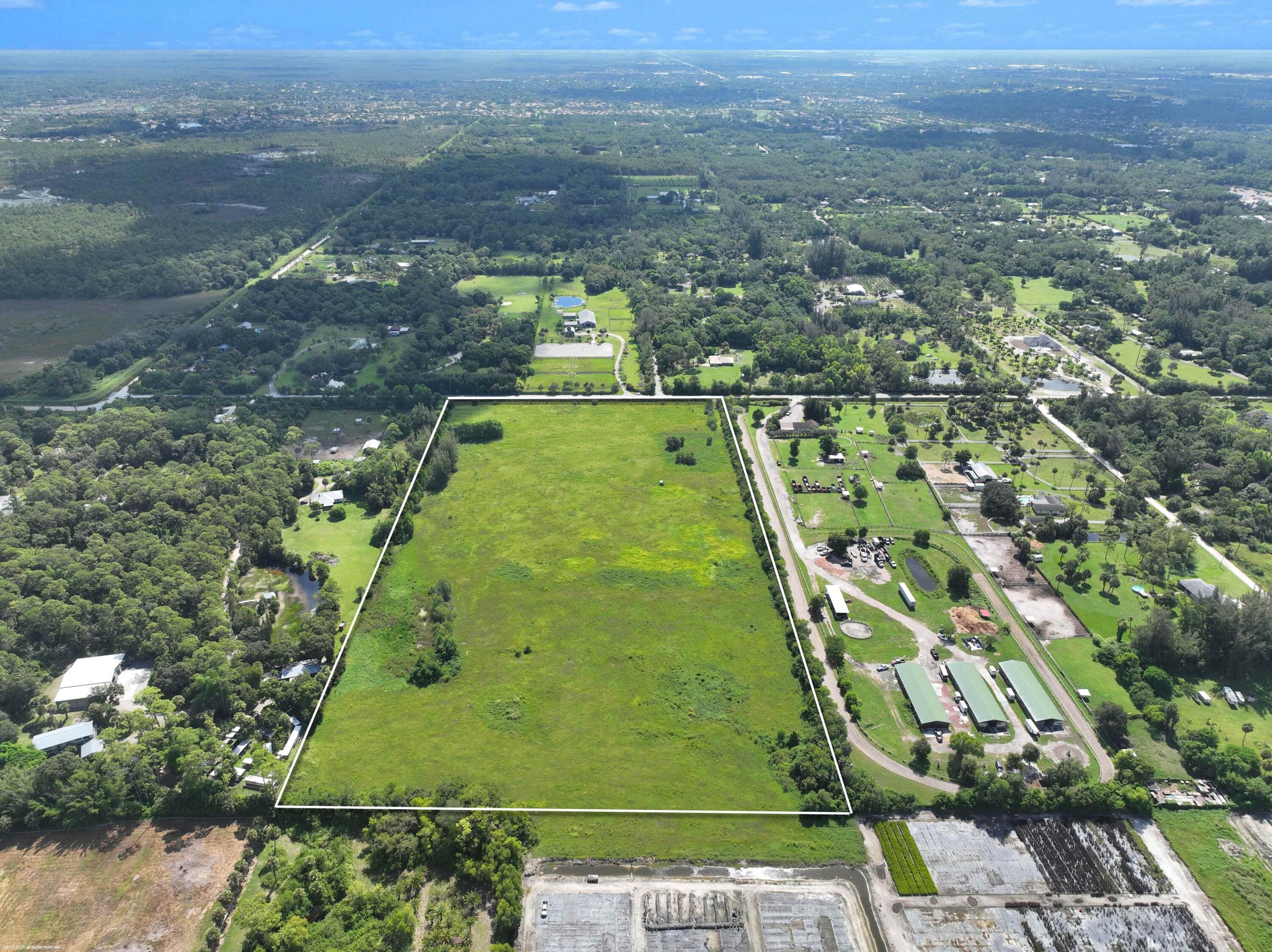 2761 E Road Loxahatchee Groves, FL 33470 - Photo 19 of 20 an aerial view of a residential houses with outdoor space and trees