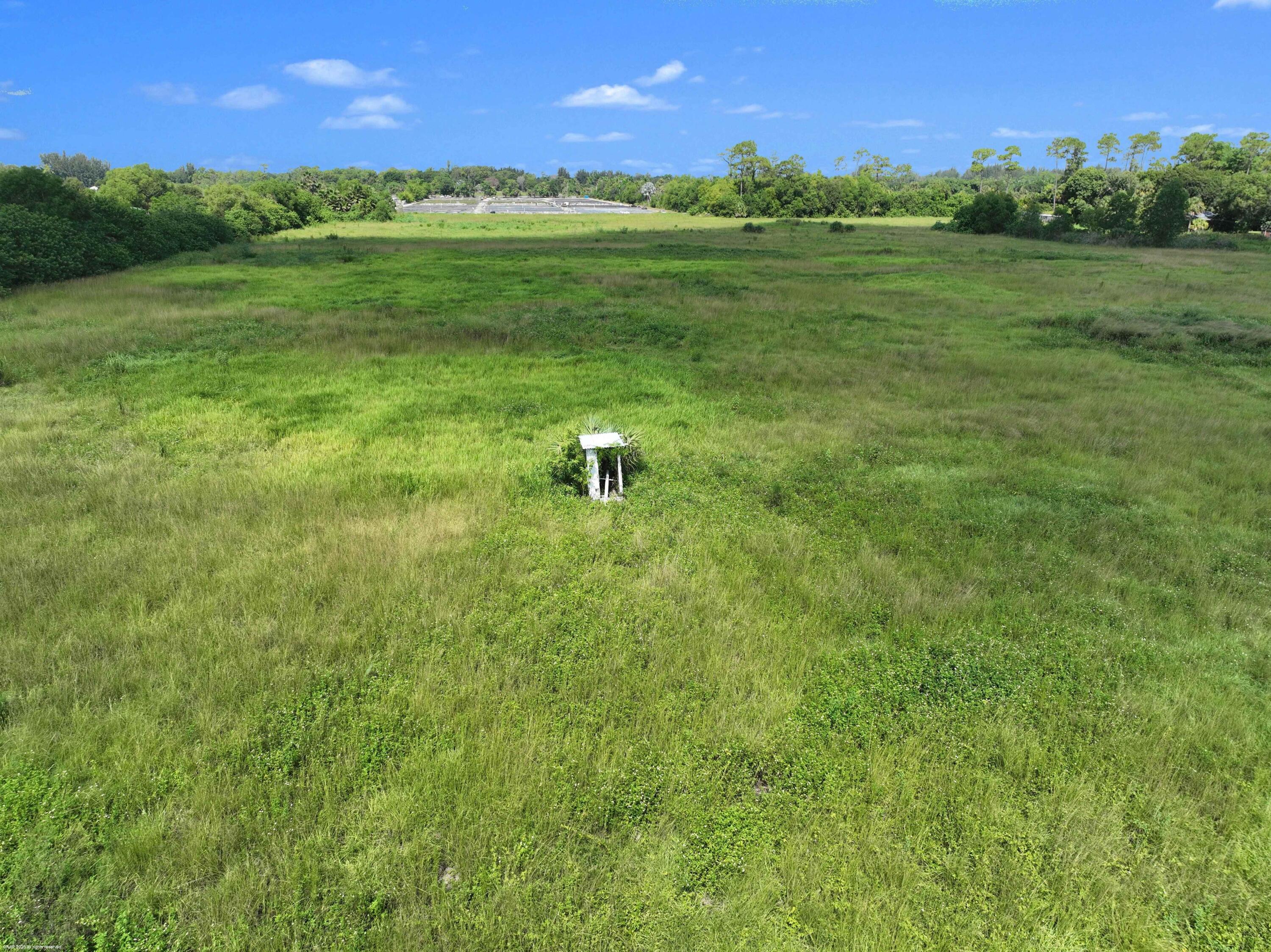2761 E Road Loxahatchee Groves, FL 33470 - Photo 9 of 20 a view of a golf course with a yard