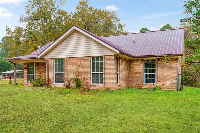 a front view of house with yard outdoor seating and green space