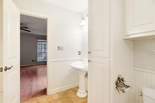 a bathroom with a sink a toilet and a mirror