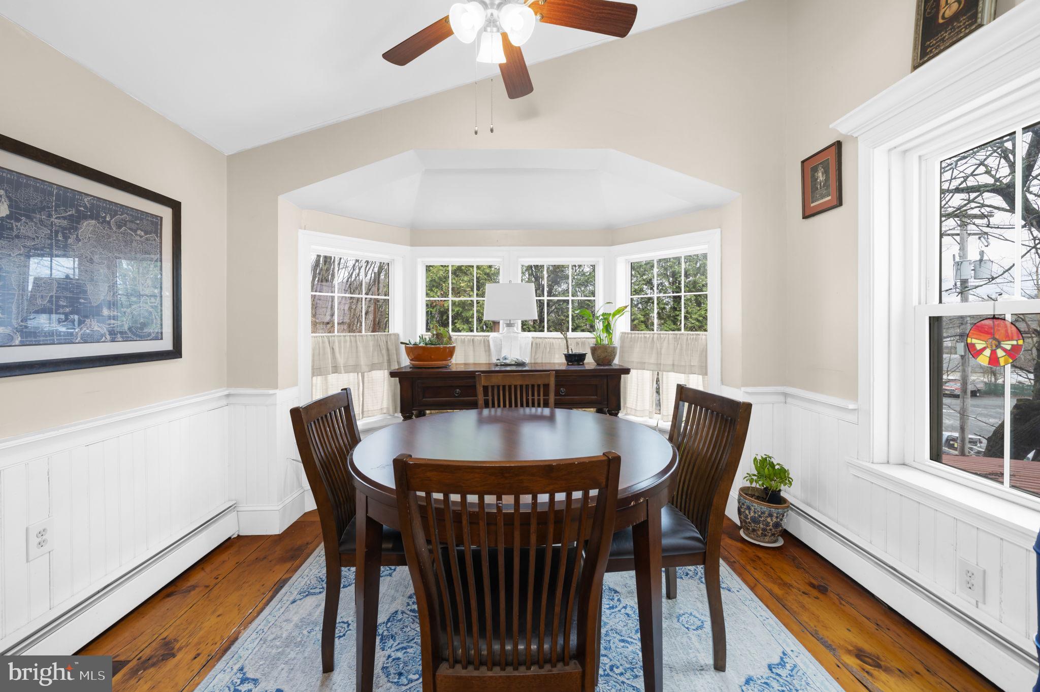 103 Gravel Pike Green Lane, PA 18054 - Photo 11 of 43 a view of a dining room with furniture a chandelier and wooden floor