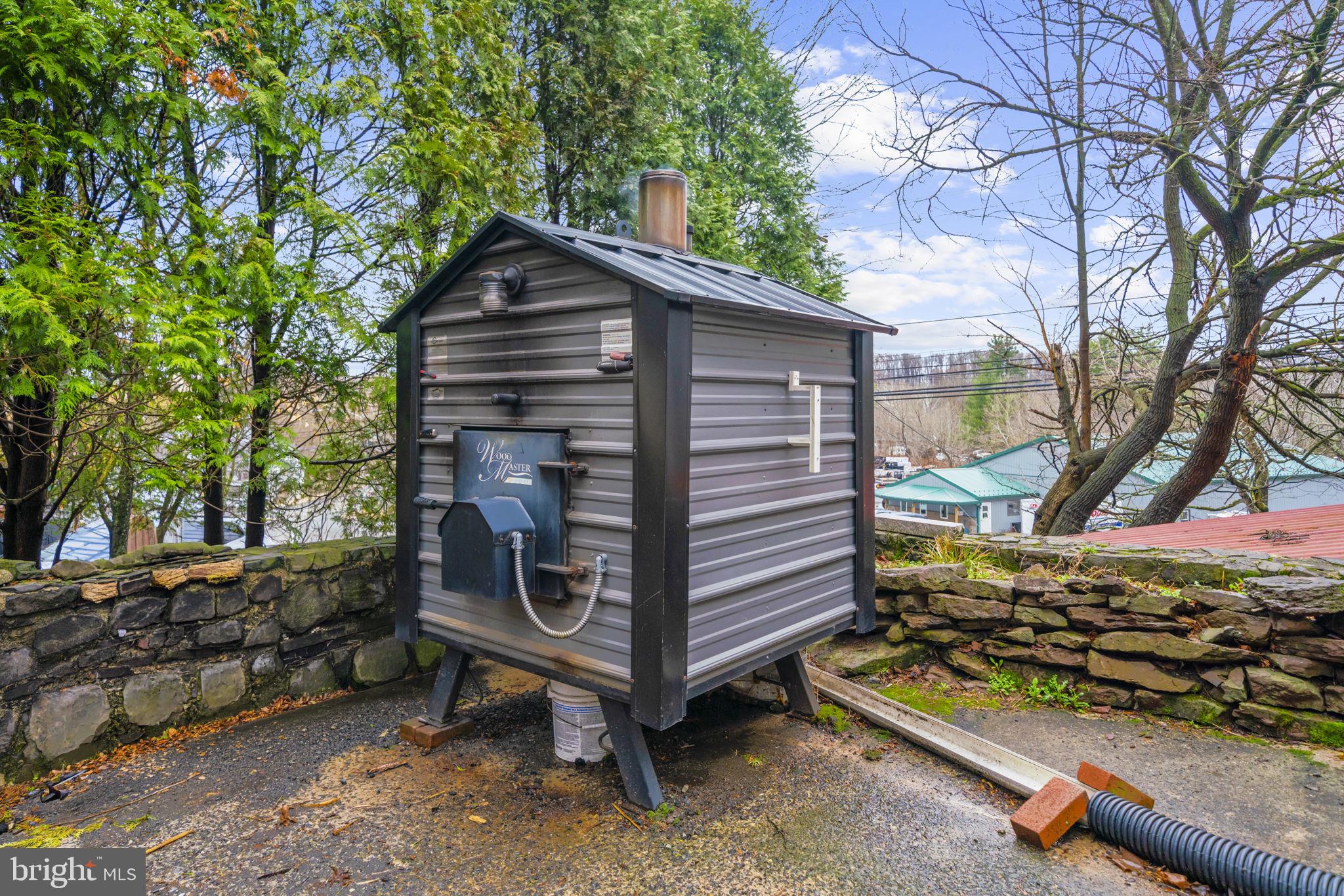 103 Gravel Pike Green Lane, PA 18054 - Photo 27 of 43 a backyard of a house with barbeque oven wooden fence and trees
