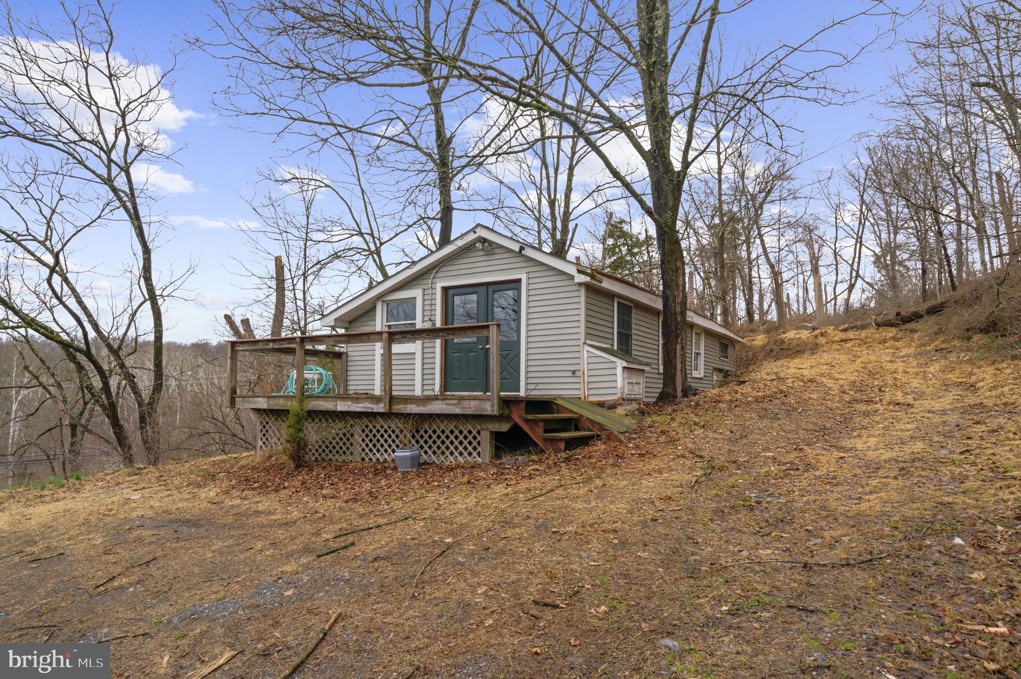 103 Gravel Pike Green Lane, PA 18054 - Photo 32 of 43 a wooden bench sitting in middle of yard