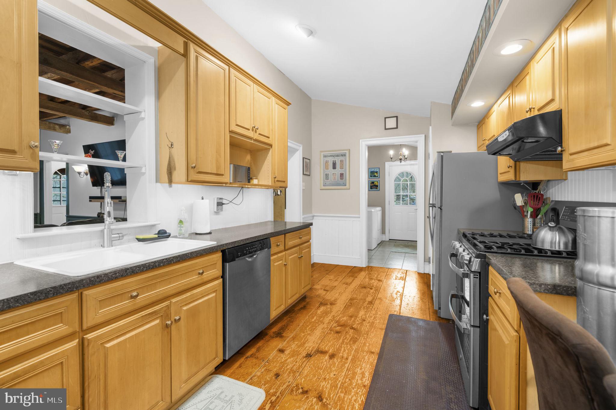 103 Gravel Pike Green Lane, PA 18054 - Photo 4 of 43 a large kitchen with stainless steel appliances granite countertop a lot of counter space and wooden floors