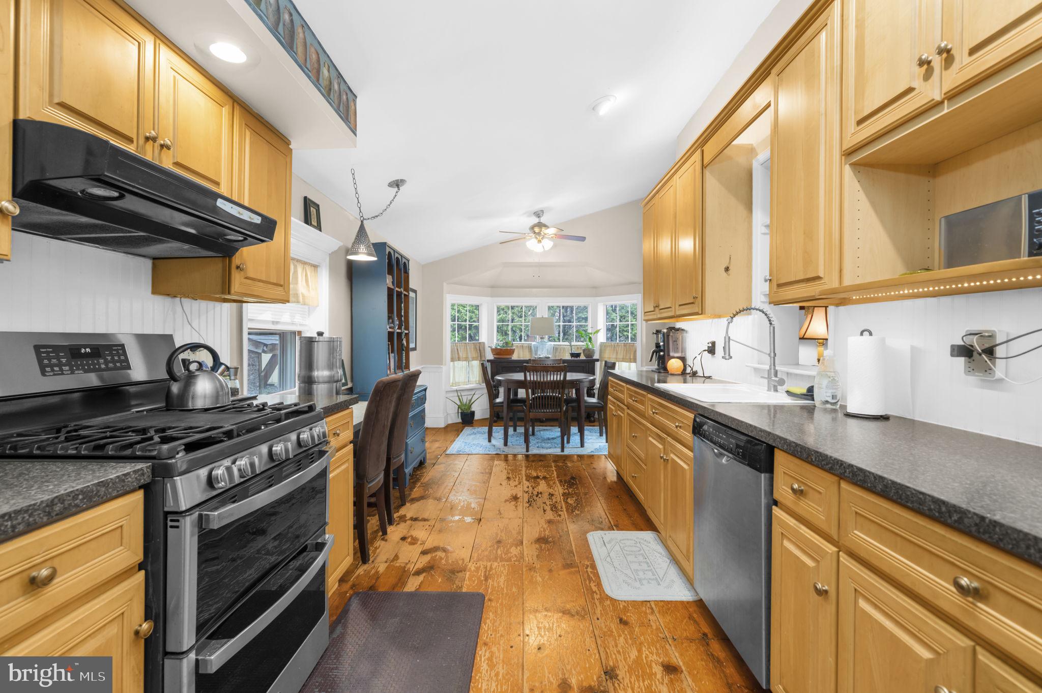 103 Gravel Pike Green Lane, PA 18054 - Photo 9 of 43 a kitchen with stainless steel appliances granite countertop a stove a sink and a microwave