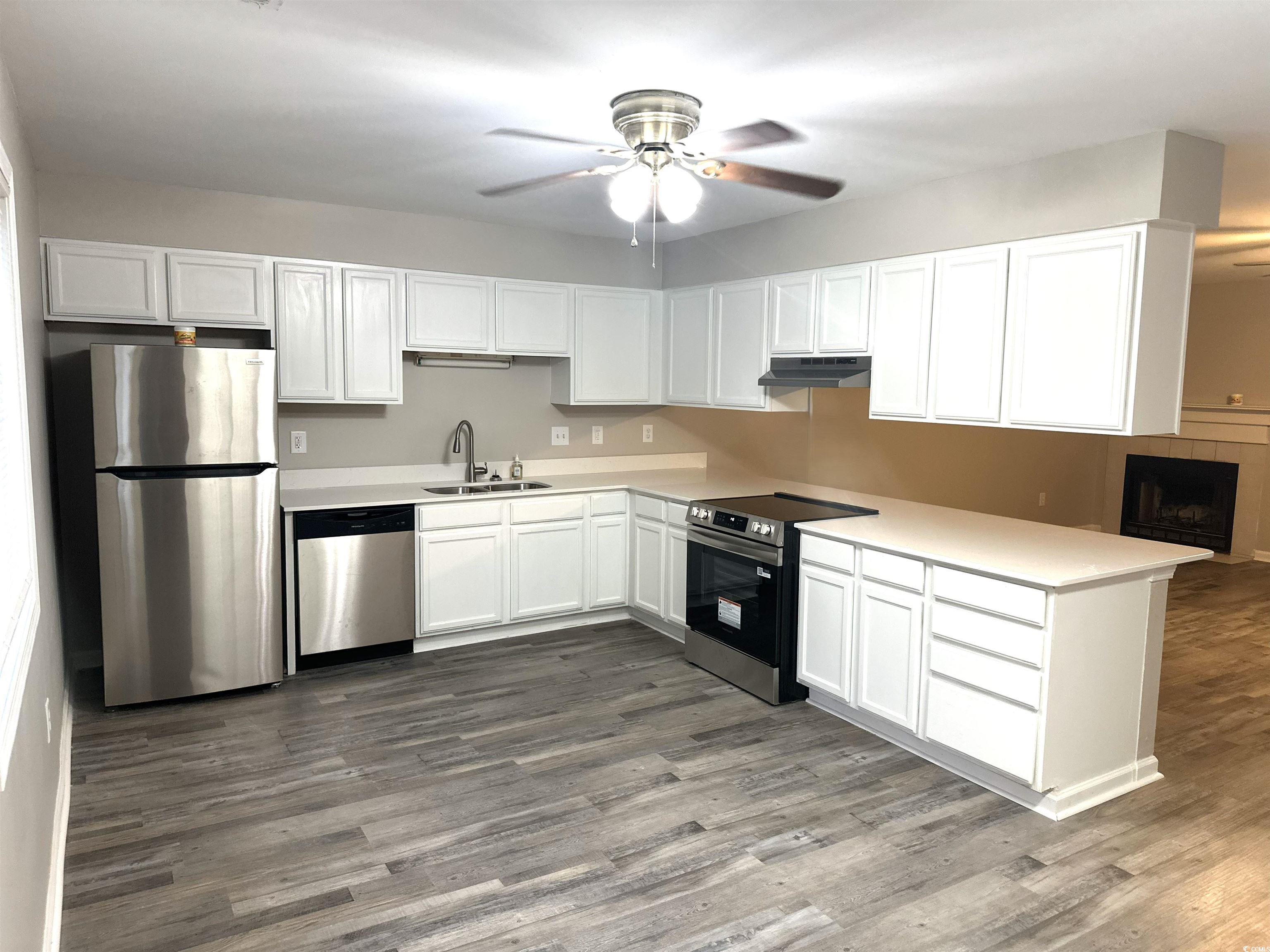 178 Beaver Pond Loop, Unit 60 Pawleys Island, SC 29585 - Photo 15 of 21 Kitchen featuring appliances with stainless steel finishes, white cabinets, dark wood-type flooring, and a ceiling fan