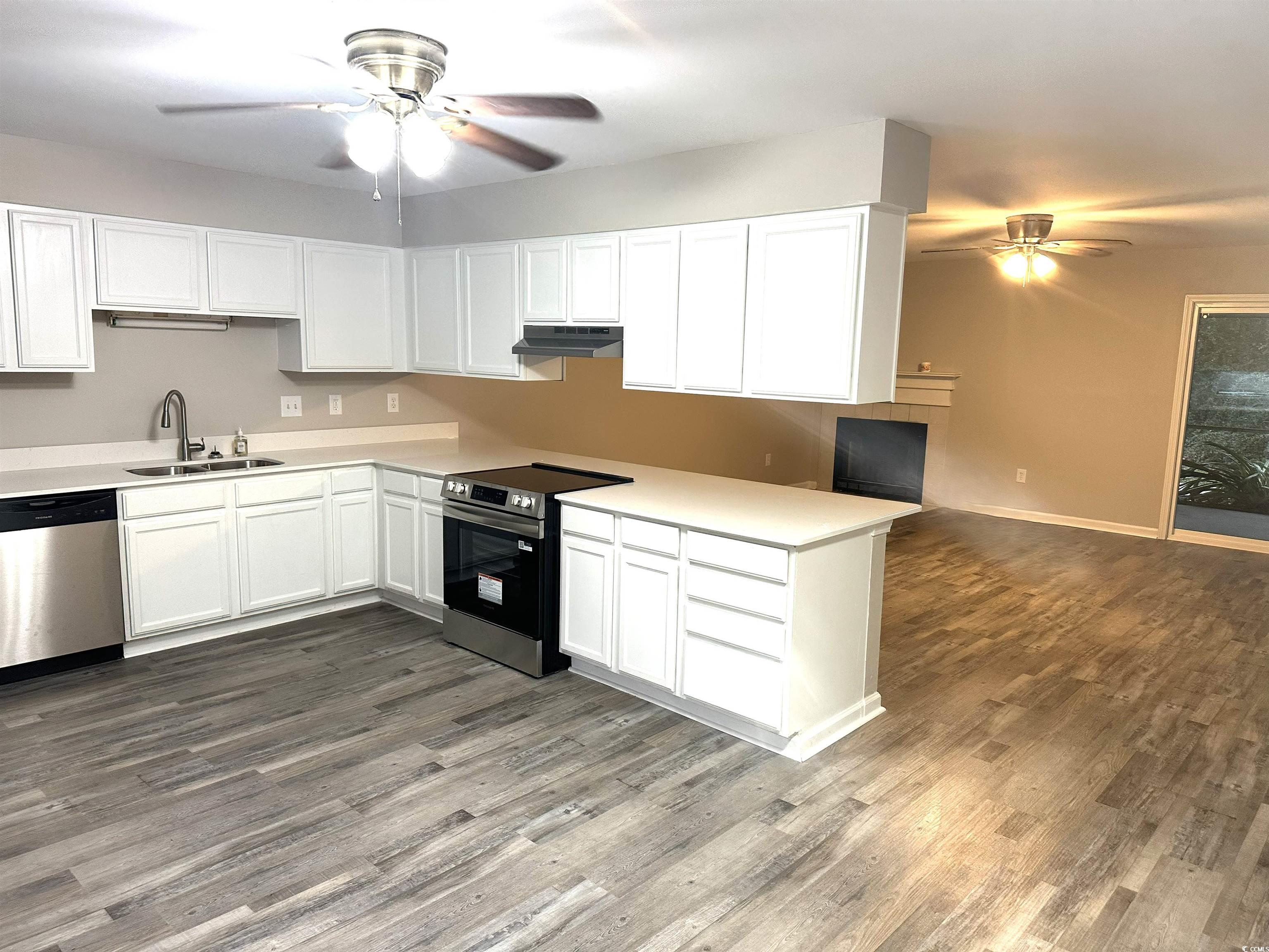 178 Beaver Pond Loop, Unit 60 Pawleys Island, SC 29585 - Photo 16 of 21 Kitchen with ceiling fan, stainless steel appliances, white cabinets, and dark wood finished floors