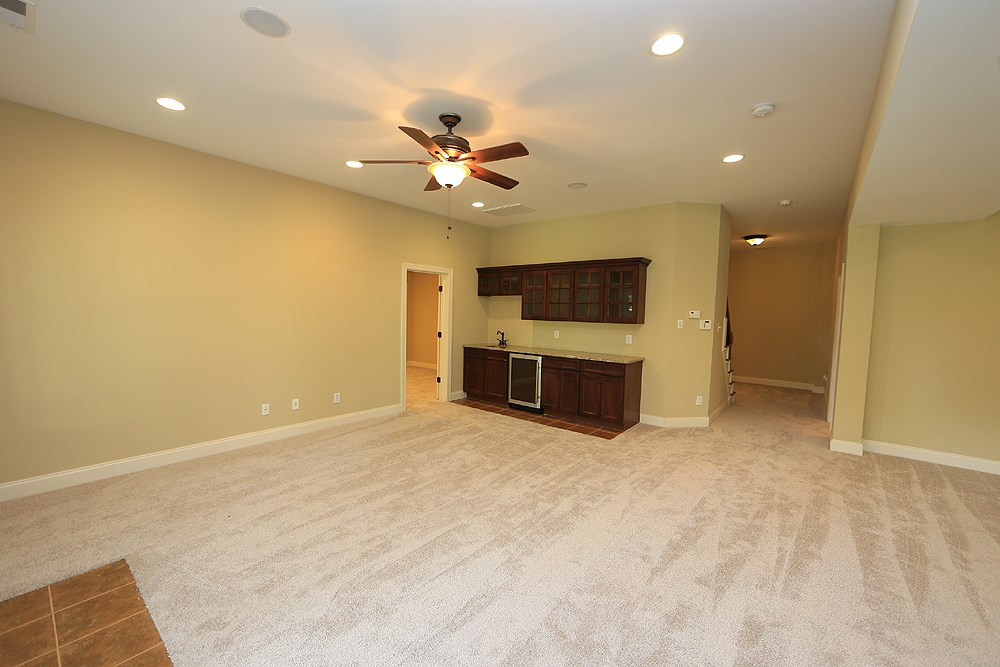637 Competition Road Raleigh, NC 27603 - Photo 28 of 30 View from the Patio Doors looking back at the cabinets, sink and built in fridge. Not pictured is a separate office space and full bath and media room. Basement