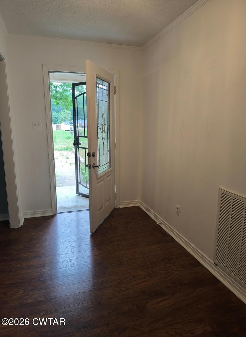 513 Viar Road Dyersburg, TN 38024 - Photo 4 of 37 a view of an empty room with wooden floor and a window