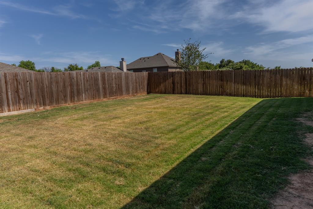 2361 Waggoner Rnch Drive Weatherford, TX 76087 - Photo 17 of 19 a bathroom with a yard and a wooden fence
