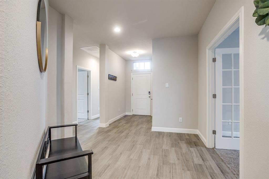 2361 Waggoner Rnch Drive Weatherford, TX 76087 - Photo 3 of 19 wooden floor in an empty room with a window