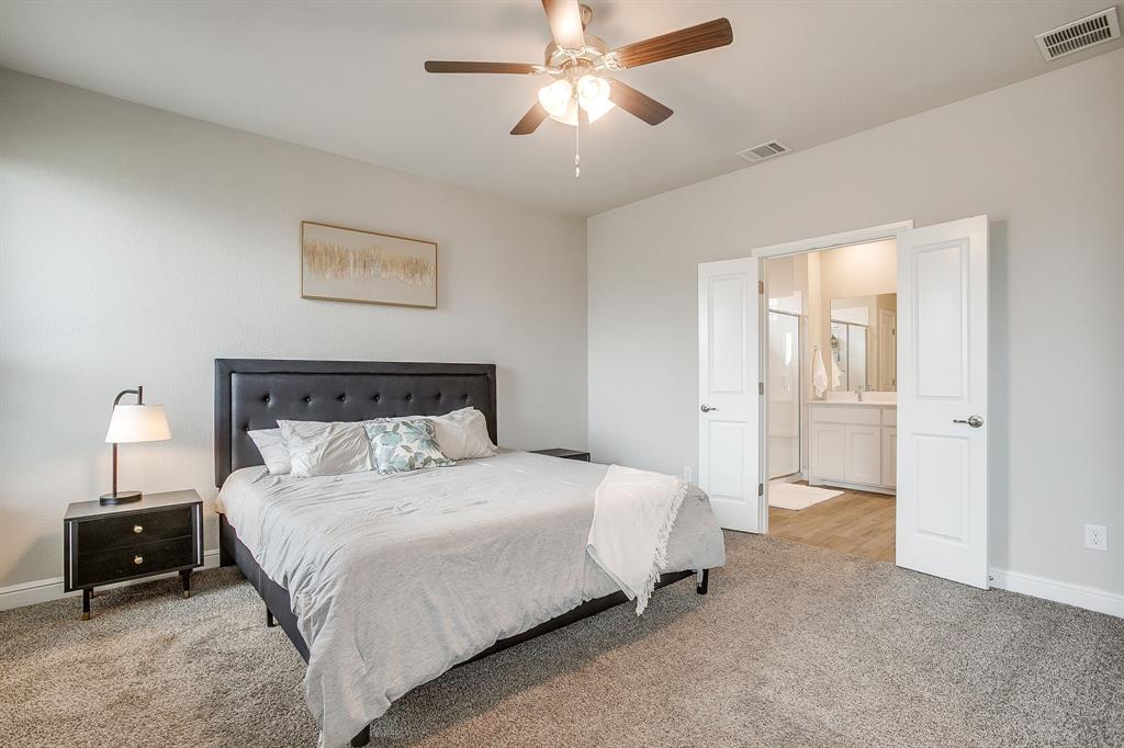 2361 Waggoner Rnch Drive Weatherford, TX 76087 - Photo 9 of 19 a bedroom with a bed and a lamp