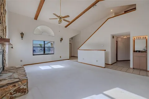 a view of a room with cabinet flat screen tv and windows