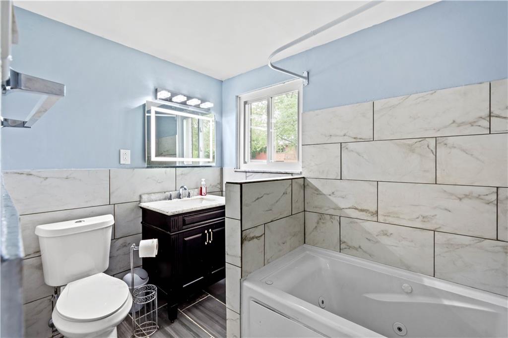 449 Decatur Avenue Pittsburgh, PA 15221 - Photo 12 of 24 a bathroom with a sink toilet and mirror