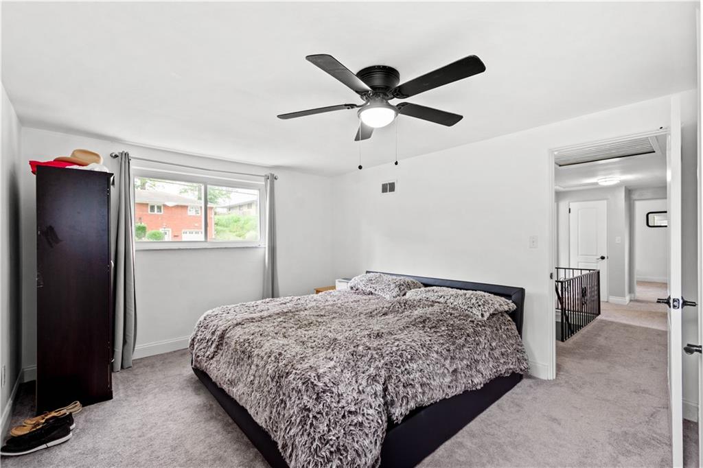 449 Decatur Avenue Pittsburgh, PA 15221 - Photo 9 of 24 a bedroom with a bed and a chandelier