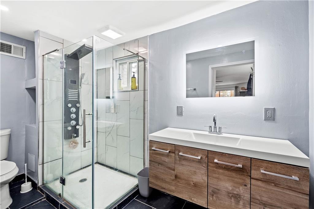 449 Decatur Avenue Pittsburgh, PA 15221 - Photo 10 of 24 a bathroom with a sink toilet and shower