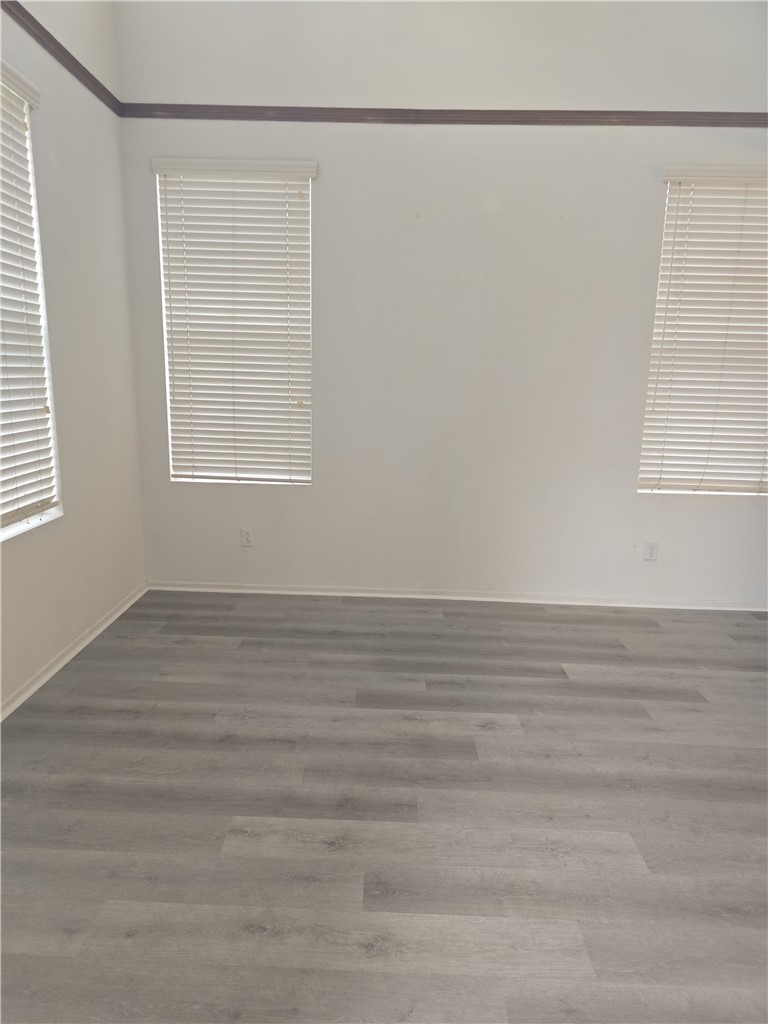 42165 Calabria Drive Temecula, CA 92591 - Photo 9 of 10 a view of an empty room with wooden floor and a window