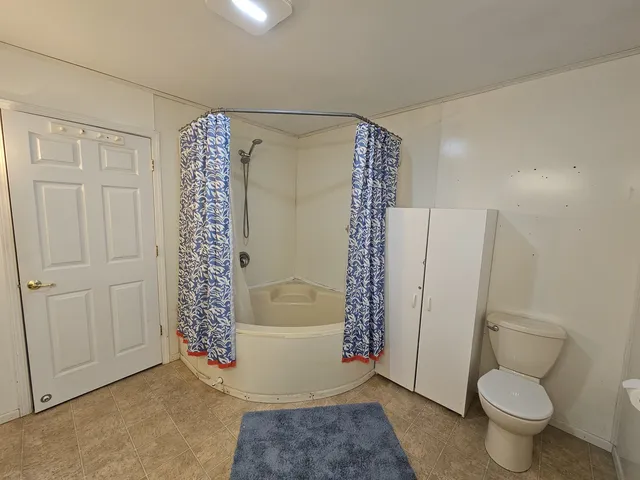 a bathroom with a toilet and shower