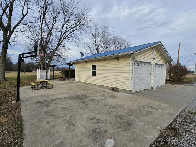 a view of a house with a yard and garage