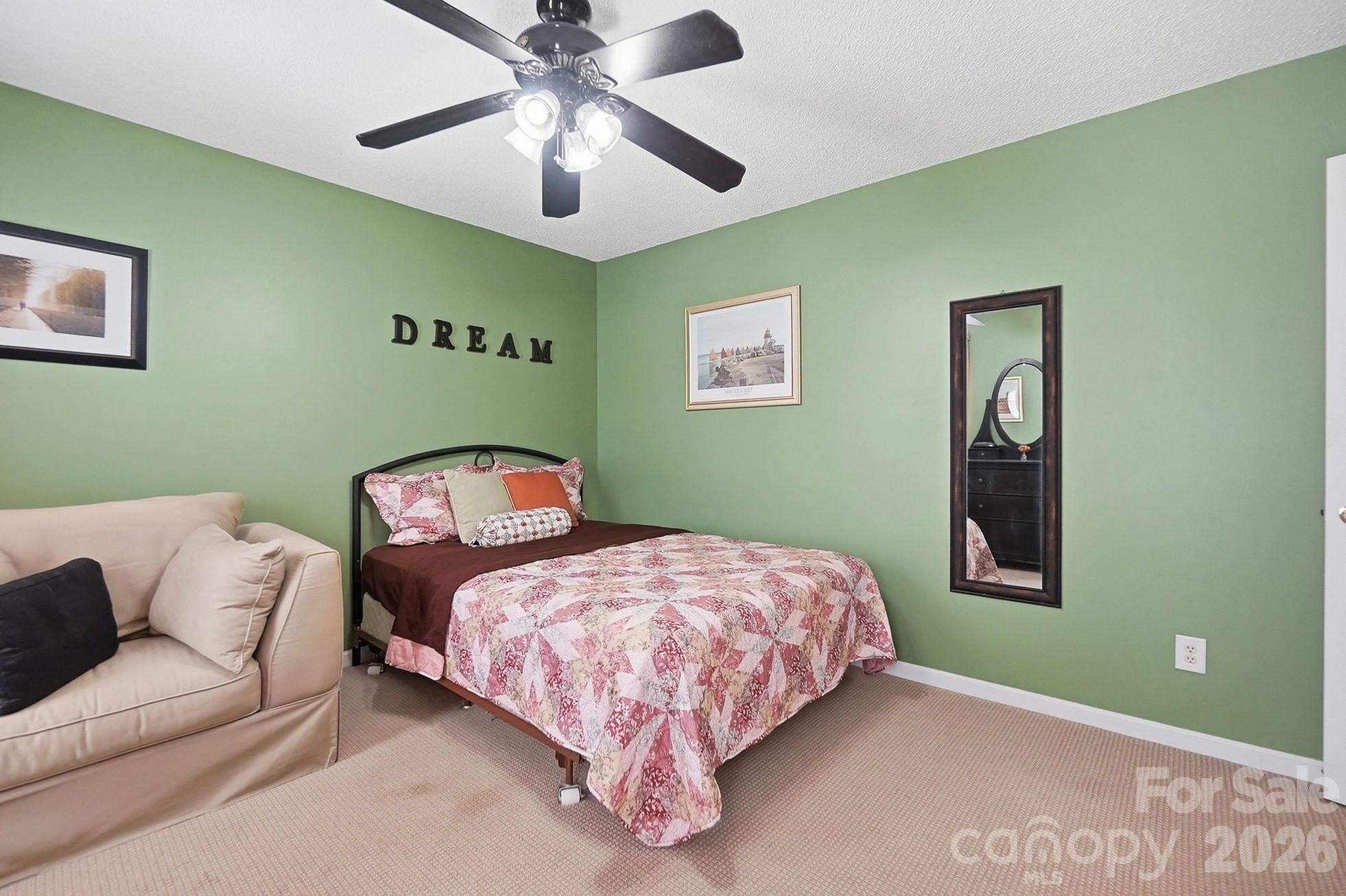 442 Sugar Maple Drive Tega Cay, SC 29708 - Photo 24 of 48 a bedroom with a bed and a chandelier