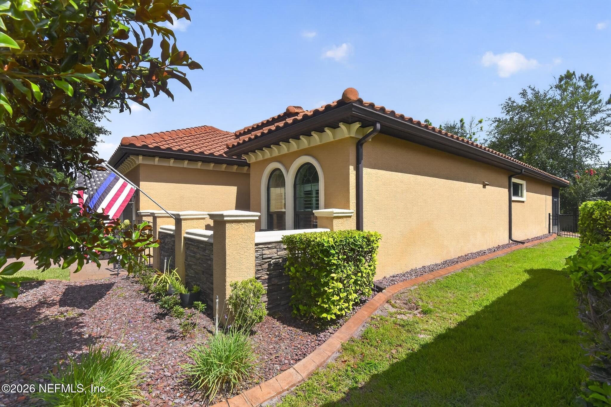 110 Vía Roma Ormond Beach, FL 32174 - Photo 39 of 43 a front view of a house with garden