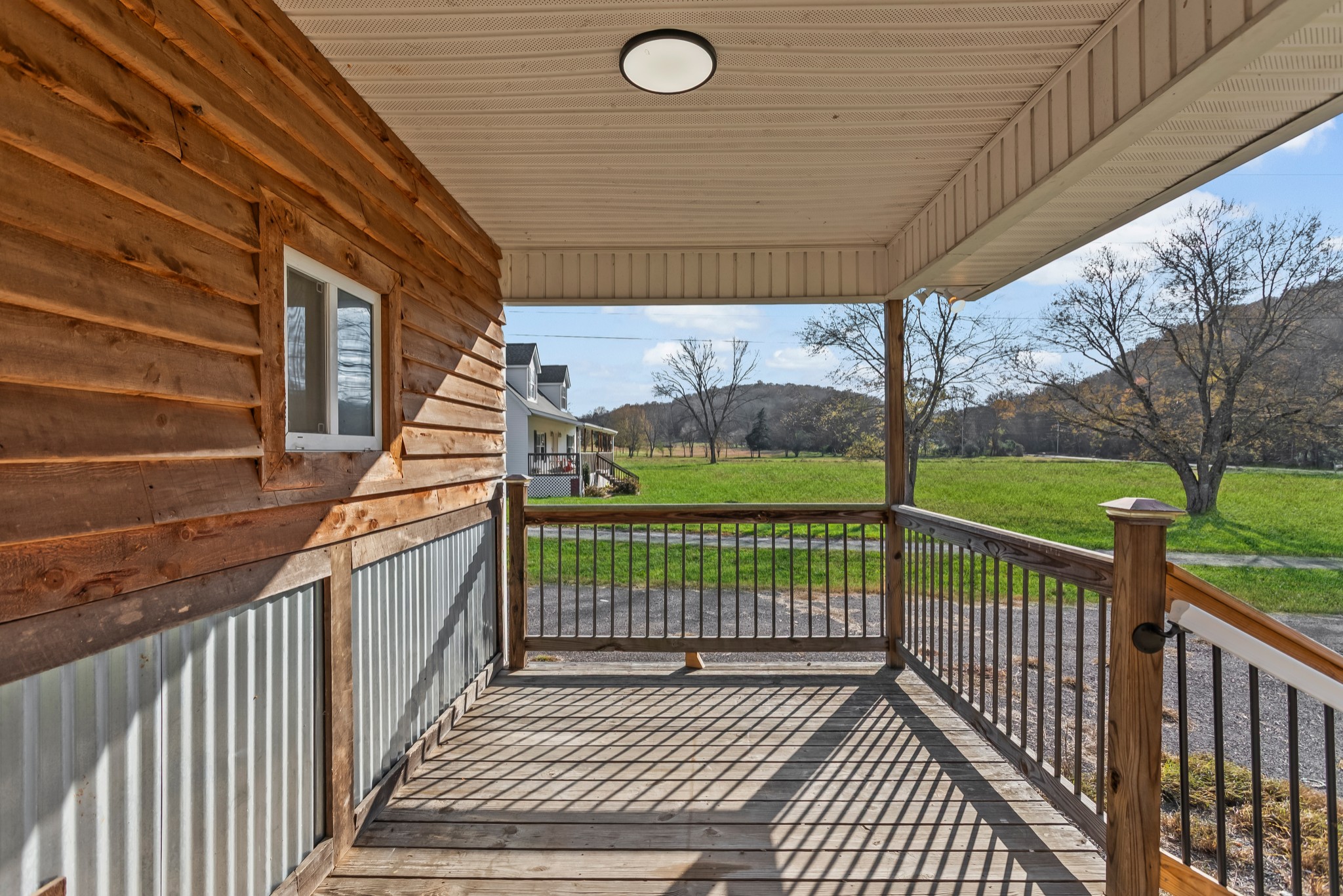 8637 Dog Branch Road Mount Pleasant, TN 38474 - Photo 2 of 44 a view of a porch with wooden floor and iron fence