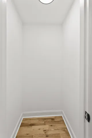 a view of a room with wooden floor