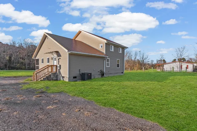 a backyard of a house with table and chairs