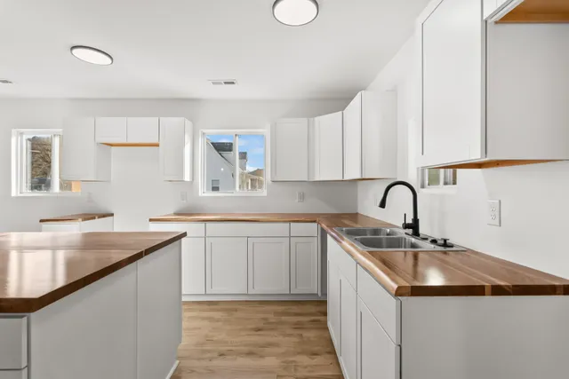 a kitchen with a sink stove and cabinets