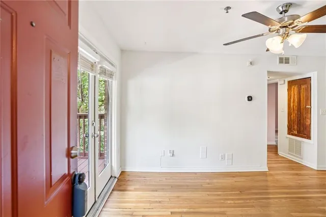 a view of a livingroom with a ceiling fan and window