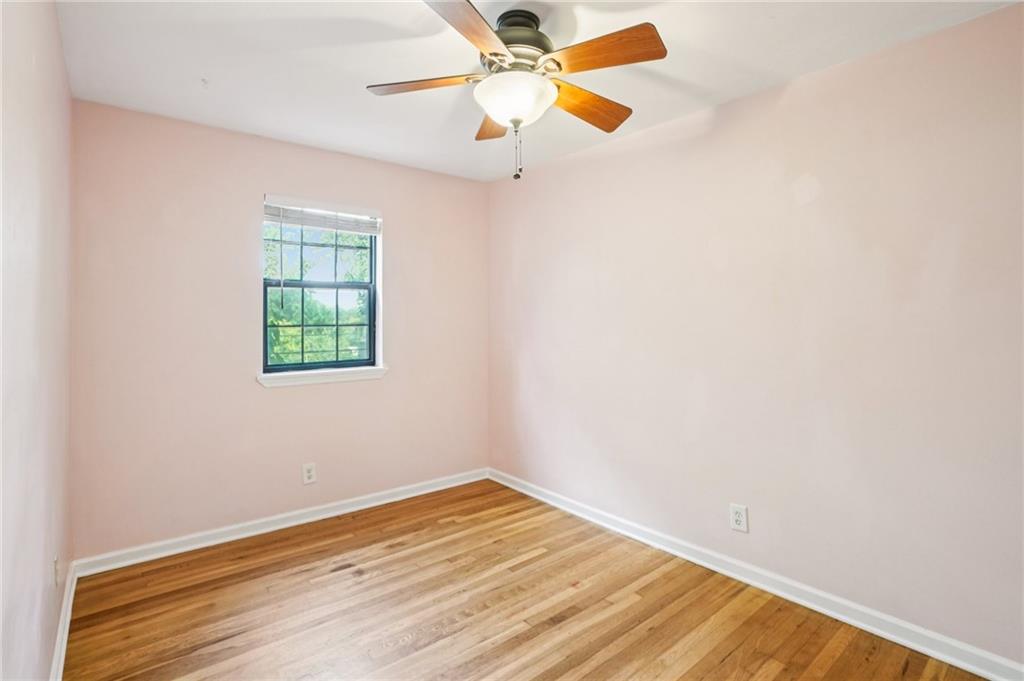 890 Glendale Terrace Northeast, Unit 1 Atlanta, GA 30309 - Photo 11 of 19 an empty room with a window and a ceiling fan