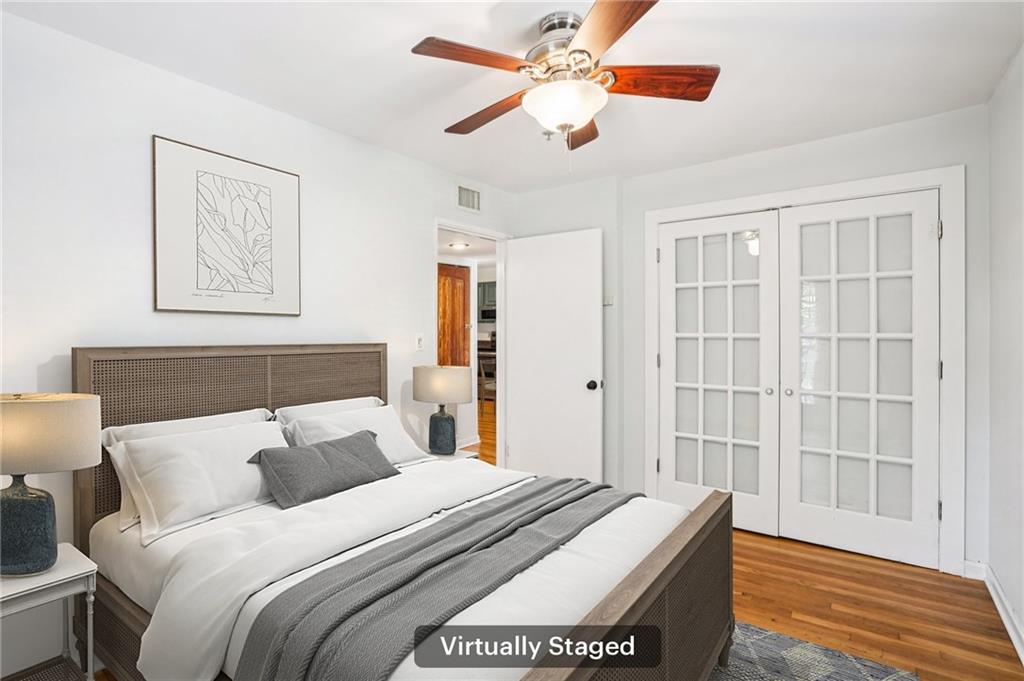 890 Glendale Terrace Northeast, Unit 1 Atlanta, GA 30309 - Photo 12 of 19 a bedroom with bed and wooden floor