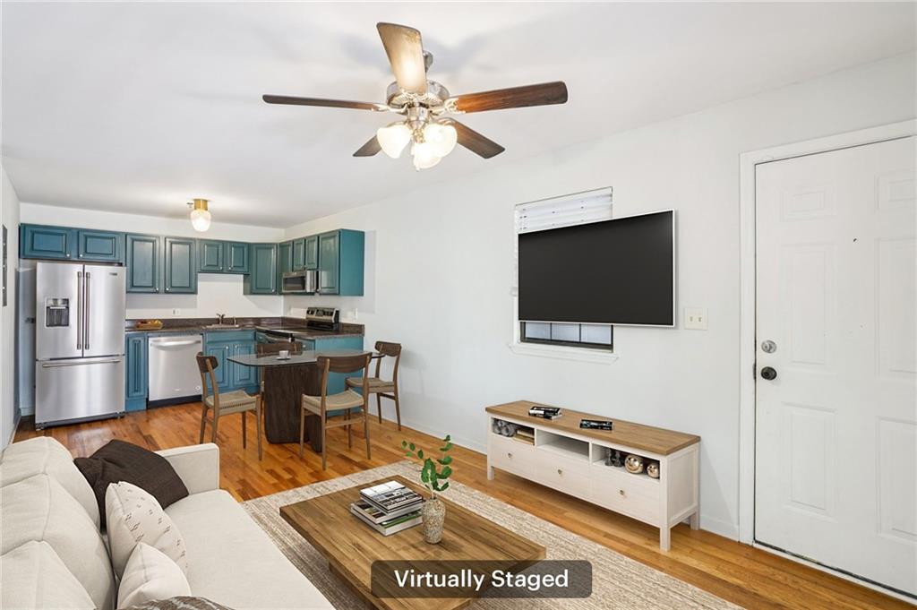 890 Glendale Terrace Northeast, Unit 1 Atlanta, GA 30309 - Photo 2 of 19 a living room with furniture and a flat screen tv