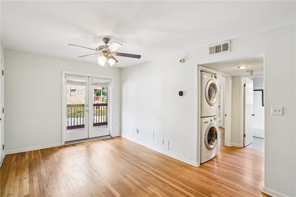 890 Glendale Terrace Northeast, Unit 1 Atlanta, GA 30309 - Photo 5 of 19 a view of a kitchen with refrigerator ceiling fan and wooden floor