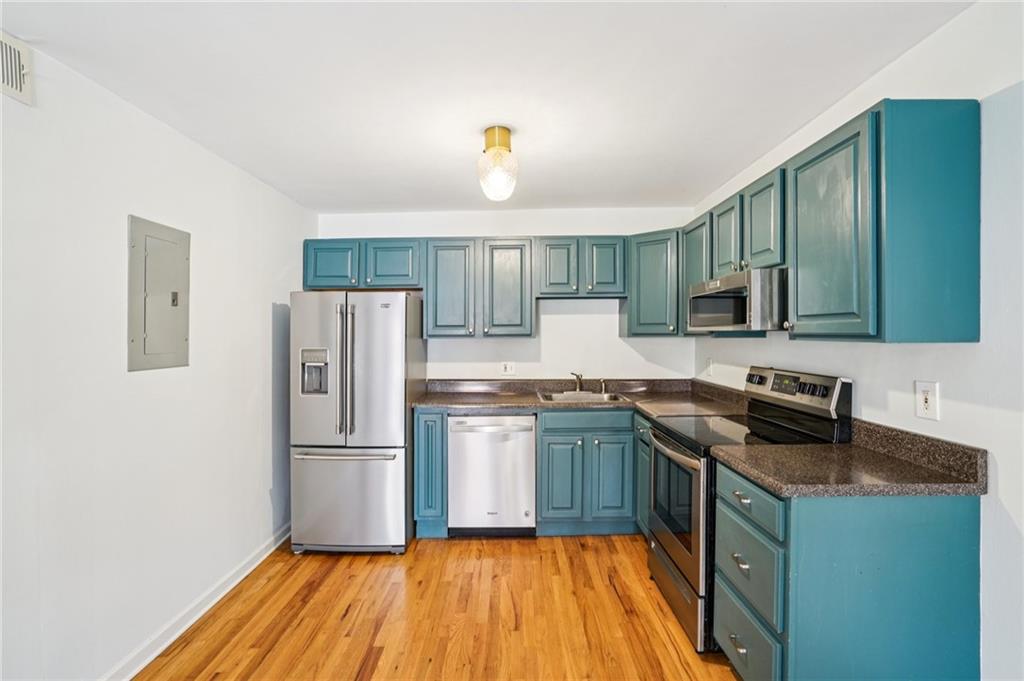 890 Glendale Terrace Northeast, Unit 1 Atlanta, GA 30309 - Photo 9 of 19 a kitchen with granite countertop stainless steel appliances and wooden cabinets